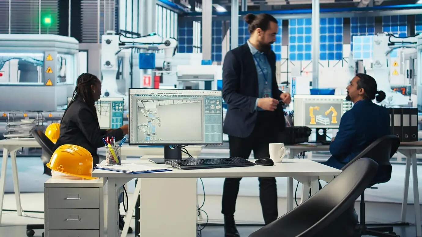 A supervisor coordinating with technicians as they inspect a photovoltaics factory.