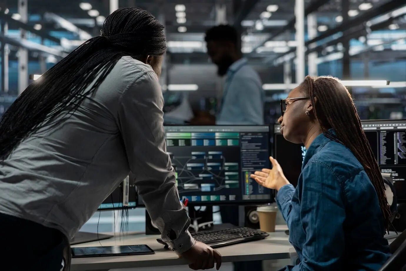 Software developers in a data center using PCs to visualize AI neural networks